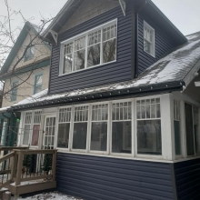 New Royal estate siding in Marine Blue color with accented ironstone corners. Front gable done in Portmouth Shake Gray Moss color. All Weather patio door installed in place of a 32 exterior door. All soffit, fascia and eaves done in black to tie it all 